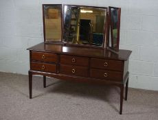 A dressing table, late 20th century, with triple mirror over six drawers, 128cm high, 130cm wide