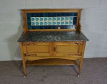 An Edwardian satin birch and marble topped washstand, circa 1910,  with a tiled gallery back,