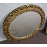A George III style oval gilt framed wall mirror, 69cm high, 78cm wide, a smaller octagonal gilt