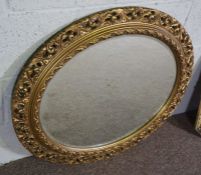 A George III style oval gilt framed wall mirror, 69cm high, 78cm wide, a smaller octagonal gilt