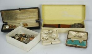 An assortment of yellow metal, mother of pearl and related studs, with three badges and similar