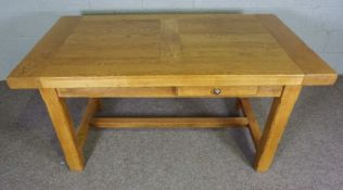 An oak refectory style extending dining table, contemporary, the rectangular planked top with two
