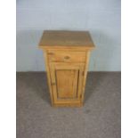 A modern pine bedside table, with single drawer and cabinet door, 80cm high, 40cm wide