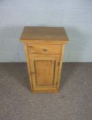 A modern pine bedside table, with single drawer and cabinet door, 80cm high, 40cm wide