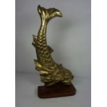 A Rococo style brass dolphin doorstop (or Koi carp), 19th century, on a mahogany mount, 59cm high