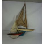 A ‘Clyde Model Dockyard’ small toy sailing boat, and another toy tin plate sailboat, inscribed to