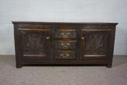 An oak low dresser, late 17th/early 18th century and later, with a plain planked top over three
