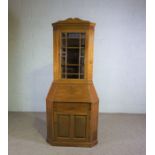 A Continental mahogany corner bureau, circa 1900,  with a glazed cabinet door over an fall front,