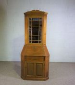 A Continental mahogany corner bureau, circa 1900,  with a glazed cabinet door over an fall front,