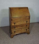 A small oak George III style bureau, with fall front and three drawers, 102cm high, 69cm wide