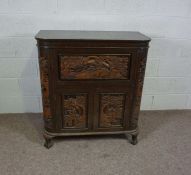 A 20th century hardwood chest, Chinese, with a rising top and cabinet doors, with integral carved