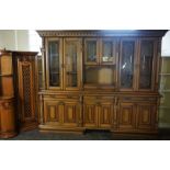 A very large modern varnished dresser, with three glazed panelled cabinets, set on a base with three