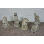 Four composition stone garden ornaments, including an otter, two spaniels and a faun  (4)