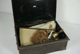 A tin box containing an assortment of items, including: a cloth bag containing ladies gloves, a