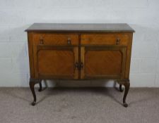 A walnut veneered side cabinet, late 20th century, with two drawers and set on cabriole legs