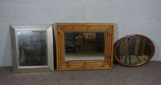 An Edwardian oval wall mirror, with chequered line inlays, 65cm high, 51cm wide, and two other