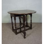 An 18th century chestnut gateleg table, with an oval top on turned supports, 67cm high, 96cm long (