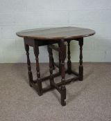 An 18th century chestnut gateleg table, with an oval top on turned supports, 67cm high, 96cm long (