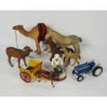 A selection of assorted carved wood animals, including a camel, with a box a various toy farm