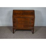A George III style mahogany veneer bureau, 20th century reproduction, with fall front and three long