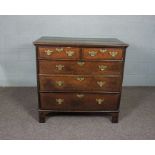 A Queen Anne oak chest of drawers, circa 1710, with a rectangular plain top with feather banding,