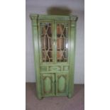 A George III style corner cabinet, 20th/21st century, with green painted decoration, fitted with two