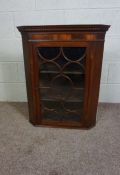 A small George III style hanging corner cabinet, 19th century,  with a moulded dentil cornice and