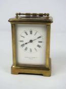 A small brass cased carriage clock, signed Mappin & Webb Ltd, Paris, in a standard plain four