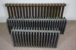 Two low cast iron Victorian style radiators, each six bars deep, with floor mounts, 95cm & 134cm