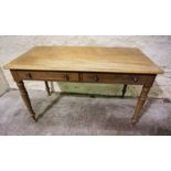 A Victorian mahogany library table, circa 1890, with a rounded rectangular top over two frieze