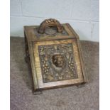 A Victorian oak coal box, carved with a lion mask within fruit of the vine, 38cm high, 45cm long