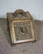 A Victorian oak coal box, carved with a lion mask within fruit of the vine, 38cm high, 45cm long