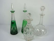 A group of assorted decanters, including a pair of flashed green cut glass tapered examples,