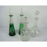 A group of assorted decanters, including a pair of flashed green cut glass tapered examples,