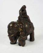 A Japanese bronze figure of an scholar riding an elephant, Meiji style, 15cm high, 13cm wide