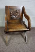 A Victorian oak Glastonbury chair, late 19th century, of typical form, the panelled back inset