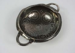 A George II silver lemon strainer, hallmarked London 1749, of circular pierced dished form, white