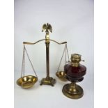 A Victorian brass and ruby glass oil lamp, with 17th century style spreading base, 32cm high;