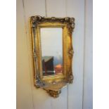 A George III style small gilt framed wall mirror, 20th century reproduction, the rectangular frame