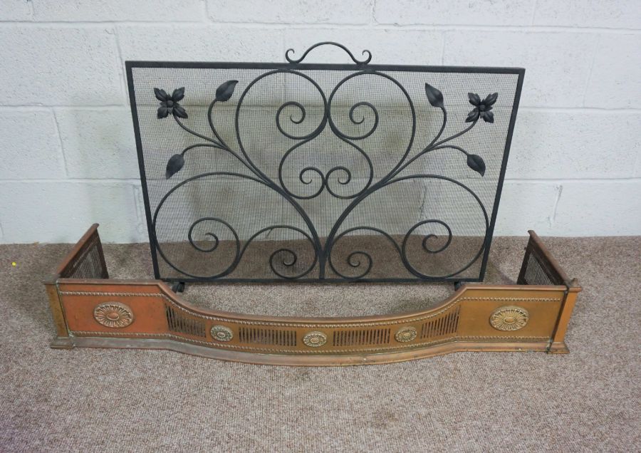 A 19th century brass fire curb, with pierced decoration, 126cm wide, and a wrought iron