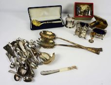 A quantity of assorted silver and silver plated flatware and related objects, including sugar tongs,