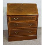 A small Edwardian mahogany bureau, with fall front opening to pigeon holes, over three drawers, 93cm