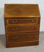 A small Edwardian mahogany bureau, with fall front opening to pigeon holes, over three drawers, 93cm