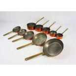 Two sets of graduated copper pans, circa 1900, each set of very small size, including five ‘