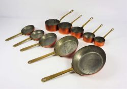 Two sets of graduated copper pans, circa 1900, each set of very small size, including five ‘