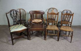 A group of assorted chairs, including a 19th century armchair, a caned tub chair, and three wheel