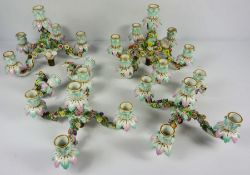 Two pairs of Dresden porcelain candelabra tops, 19th century, one with four arms, 28cm wide, and one