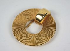 An Art Deco gold sun brooch, signed CARTIER, and marked 14K, of circular form, with engine turned