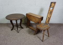 A small 19th century spinning chair, the back and seat later decorated with a dragon, together