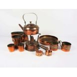 A quantity of assorted copperware, including an unusual large hip flask, spirit burner, kettle,